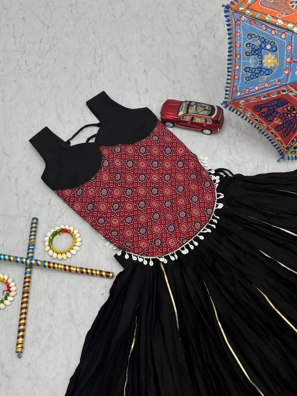 Black And Red Traditional Flared Lehenga With Printed Blouse.