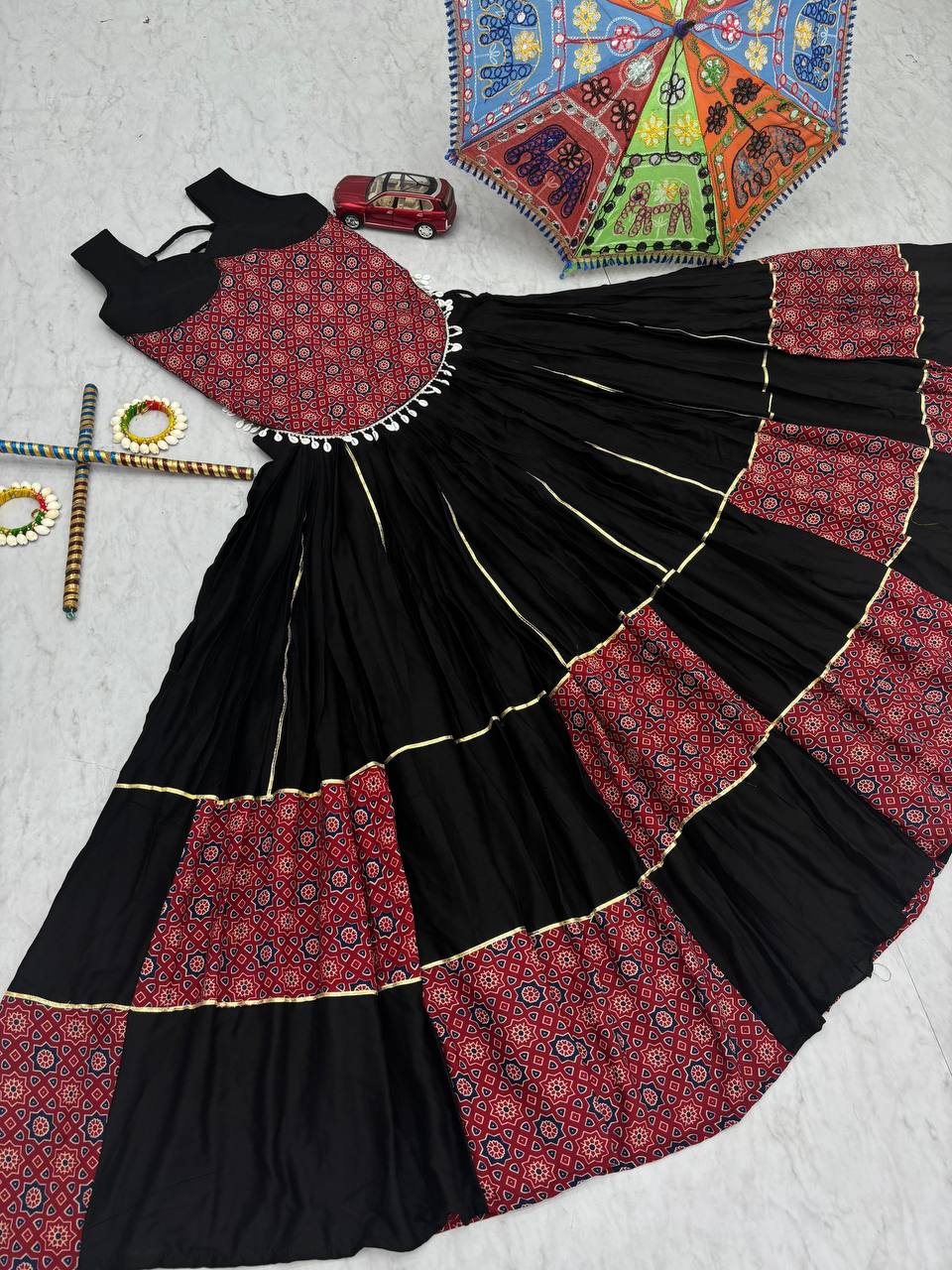 Black And Red Traditional Flared Lehenga With Printed Blouse.
